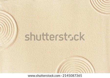 Pattern in Japanese Zen Garden with concentric circles on sand, concept for meditation, relaxation, tranquility. Aesthetic minimalist ornament sandy background. Beauty and spa backdrop. Top view.