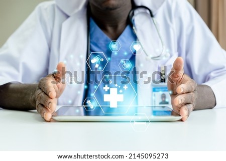 African American man doctor with medical icons on tablet analysis technology equipment medicine healthy, Medical doctor technology and healthcare concept. Royalty-Free Stock Photo #2145095273