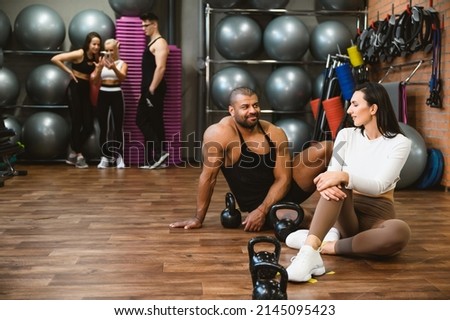 Group of multi racial sportive people in a gym. Happy sporty friends in a weight room while training - Concepts about lifestyle and sport in a fitness club