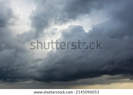 Powerful cumulus clouds with a dark base, a harbinger of bad weather and heavy rains Royalty-Free Stock Photo #2145096053