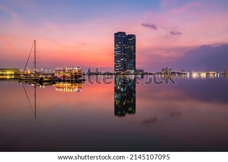 Ras Al Khaimah Boat and DhowCruise bay with harbour in background with Sunset Reflection Royalty-Free Stock Photo #2145107095
