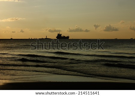 Ship silhouette on sunset background
