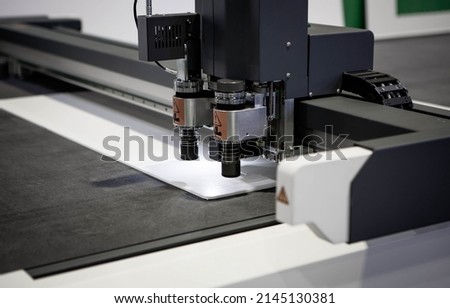 Digital die cutter machine cutting PP flute board. Industrial manufacture. Royalty-Free Stock Photo #2145130381