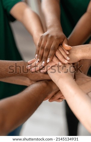 charity, support and volunteering concept - close up of volunteers stacking hands at distribution or refugee assistance center Royalty-Free Stock Photo #2145134931