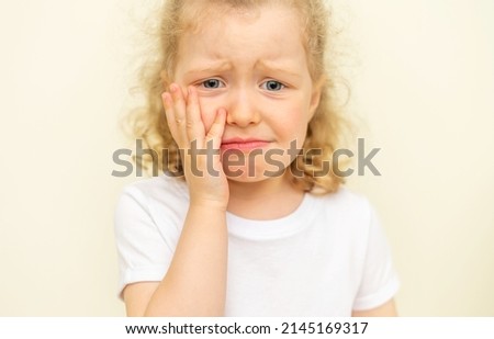 The child has a toothache. Children's caries in the initial stage. Royalty-Free Stock Photo #2145169317