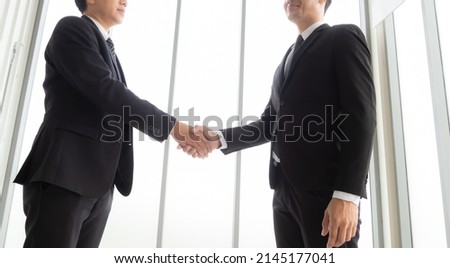 Handshake image of businessman congratulating after successful business dew isolated on white background.