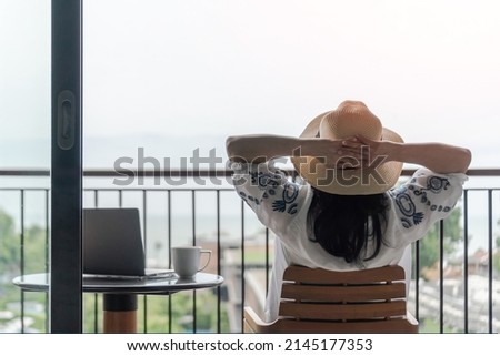 Work-Life balance, life quality, work from home and travel concept with business woman relaxing, take it easy, resting in  hotel resort, condominium, or apartment luxury living room with notebook