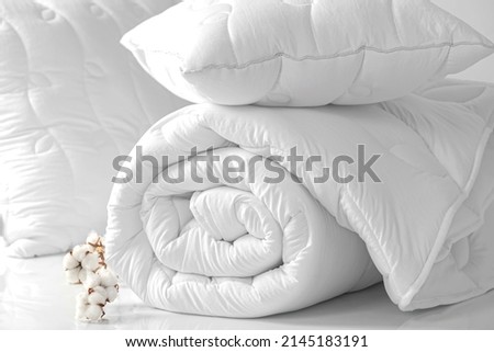 Two pillows and a folded blanket on a white background. Bedding items on a white background. Bedding catalog Royalty-Free Stock Photo #2145183191