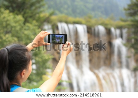 woman tourist taking photo with smart phone 