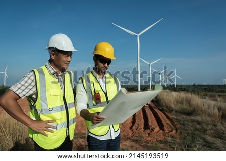 Two maintenance  planning  discuss Project in wind turbine farm. Royalty-Free Stock Photo #2145193519