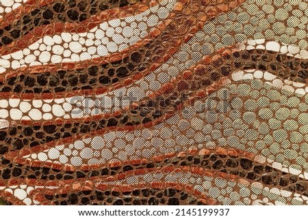 Embossed genuine leather, pattern of leopard close-up, texture and natural background, fashion trend of jungle, exotic brown shades, Fashionable pattern for background, banner, poster. Copy space