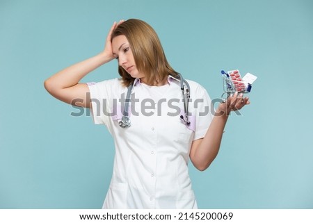 high price of drugs and medicine. Inflation, imitation. A woman doctor shows a miniature basket of medicines, on a blue background. Copy paste. healthcare concept.
