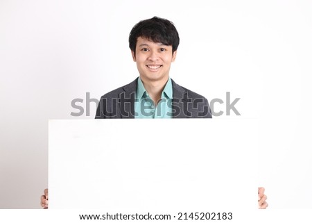 The young adult businessman standing on the white background.