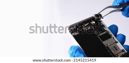 Technician repairing the Cell phone parts and tools for recovery repair phone smartphone and upgrade mobile technology,the concept of computer hardware inside.