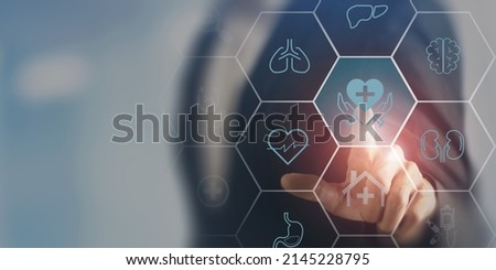 Internal organ protection. Critical illness insurance. Hand touching on protection, treatment, prevention and patronage health icon with internal organs; heart, brain, kindneys, liver, lungs, stomach. Royalty-Free Stock Photo #2145228795