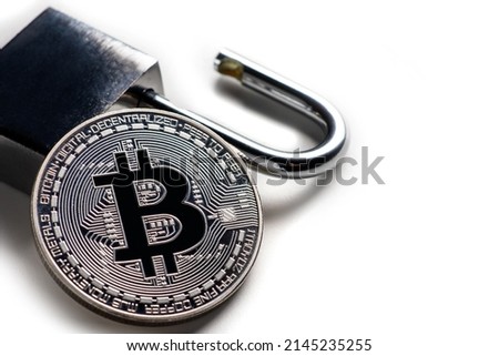 Digital currency, silver bitcoin with open padlock on white.