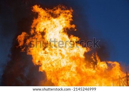 Raging flames of huge fire at night. Firestorm close up. Burning fire full frame. Bright inferno flames. Hell fire explosion. Blaze fire texture. Burning bright Bonfire. Intense combustion and heat.  Royalty-Free Stock Photo #2145246999