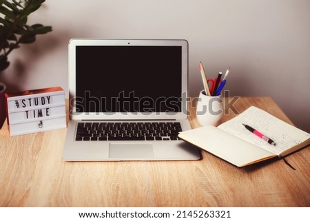 desktop with computer and notepad. study time is running out. lightbox with inscription study time
