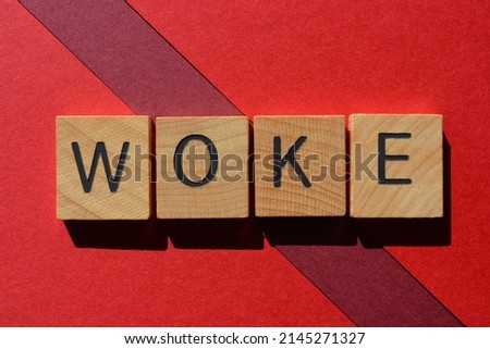 Woke, word in wooden alphabet letters isolated on red background