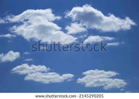 Beautiful scattered cumulus white clouds against the blue sky, copy space. Blue sky with clouds, free space. Texture. The background.