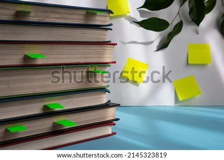 A stack of books with bookmarks on a light background with space for text. the concept of reading books on paper. Royalty-Free Stock Photo #2145323819
