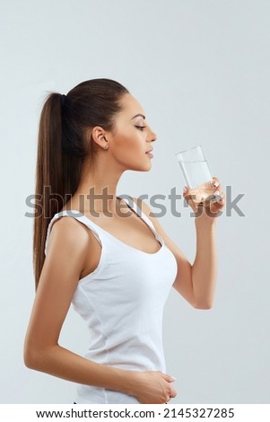 Beautiful woman holding water glass. Drink water. Girl with glass of water. Diet concept