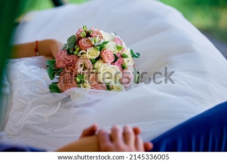 bridal bouquet lies on a lace white wedding dress pink roses with eustoma hand