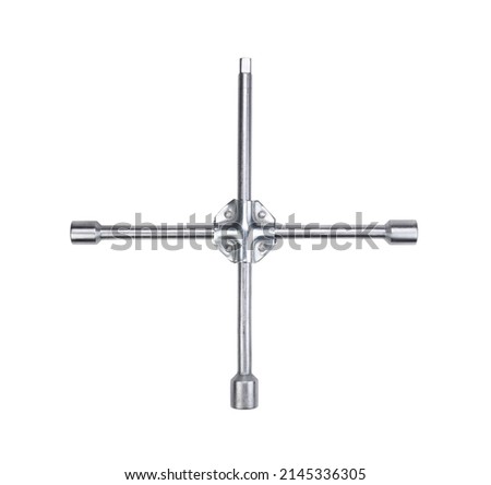 Steel chrome plated cross shaped car wrench isolated on white background.