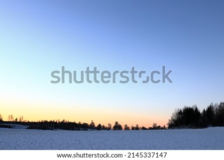 Relaxing sunrise during the winter. Calm Swedish landscape photo. Snow and golden hour. Skokloster, near Stockholm, Sweden.