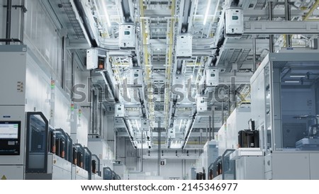 Dolly Shot Inside Bright Advanced Semiconductor Production Fab Cleanroom with Working Overhead Wafer Transfer System  Royalty-Free Stock Photo #2145346977