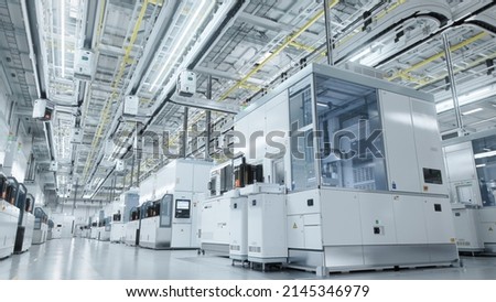 Establishing Shot Dolly Shot Inside Bright Advanced Semiconductor Production Fab Cleanroom with Working Overhead Wafer Transfer System  Royalty-Free Stock Photo #2145346979