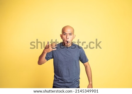 asian bald man opening his mouth with spiciness expression Royalty-Free Stock Photo #2145349901