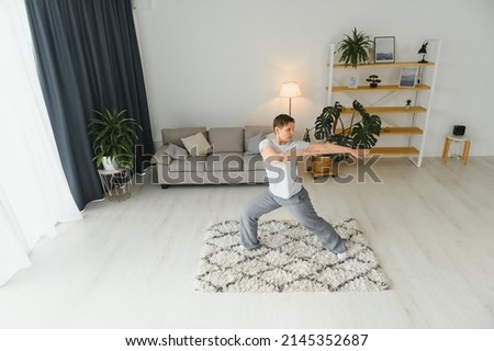Adult woman doing fitness exercises at home. Senior woman do stretching exercises. Mature woman doing yoga poses.