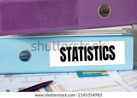 Text STATISTICS on blue office folder on white background