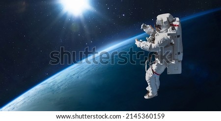 Astronaut in space. Spaceman on orbit of Earth planet surface. Sci-fi wallpaper. Elements of this image furnished by NASA