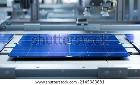 Solar Panel Cells are  Being Moved and Tested on Conveyor during Solar Panel Production Process on Advanced Factory Royalty-Free Stock Photo #2145363881