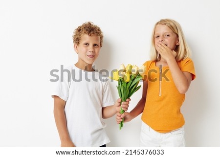 picture of positive boy and girl fun birthday gift surprise bouquet of flowers lifestyle unaltered