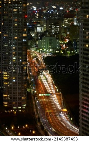 The night view of the wide Kaigan dori motorway among the skyscrapers of Shinbashi. Tokyo. Japan
