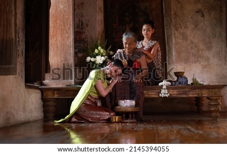 Daughter, granddaughter visit to respect Mother or elder on Songkran day , Family day lifsetyle in Thailand .  Royalty-Free Stock Photo #2145394055