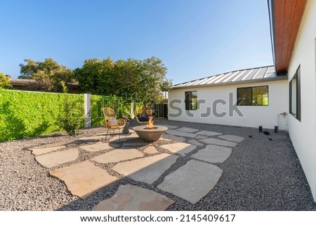 An outdoor patio area with a fire pit Royalty-Free Stock Photo #2145409617