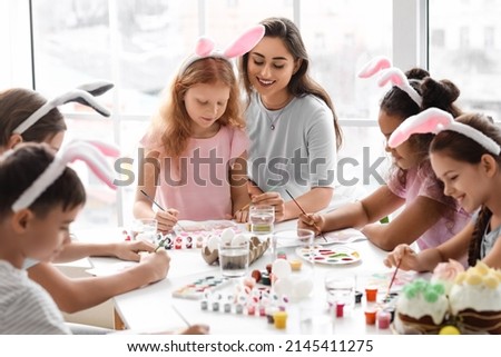 Cute children attending master-class in art on Easter eve