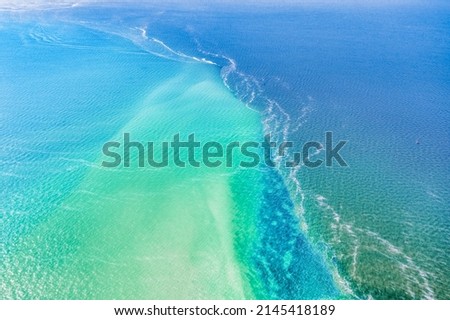 Meeting of two seas, Kinburn Spit, Ukraine, amazing aerial view. The border of the blue Black Sea and the Dnieper river, wild nature, beautiful landscape, in bright sunny weather. Royalty-Free Stock Photo #2145418189