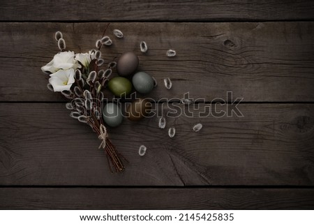 dark Easter card with a bouquet and eggs on a wooden background