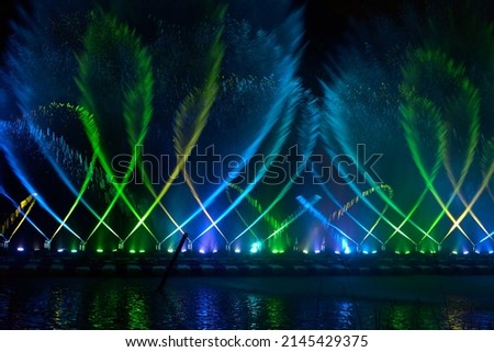 Artistic water dancing fountain at night Royalty-Free Stock Photo #2145429375