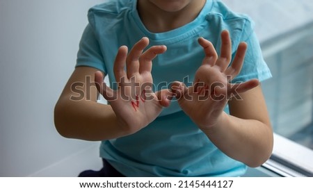 a little boy has an inscription on his palms no to war. selective focus