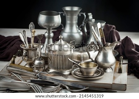 Silver dishes on old background Royalty-Free Stock Photo #2145451319
