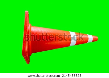 one red traffic cone on a green background