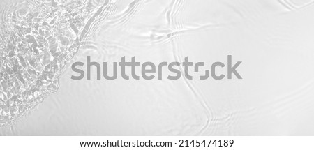 Transparent white clear water wave surface texture with splashes and bubbles. Abstract summer banner background Water waves in sunlight with copy space Cosmetic moisturizer micellar toner emulsion Royalty-Free Stock Photo #2145474189