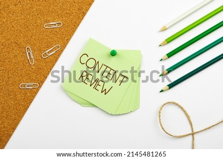 Sign displaying Content Review. Conceptual photo evaluate the processes that assess and improve content Multiple Assorted Collection Office Stationery Photo Placed Over Table