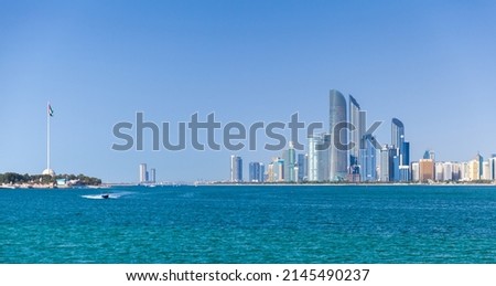 Abu Dhabi on a sunny day, cityscape with tall skyscrapers under clear blue sky